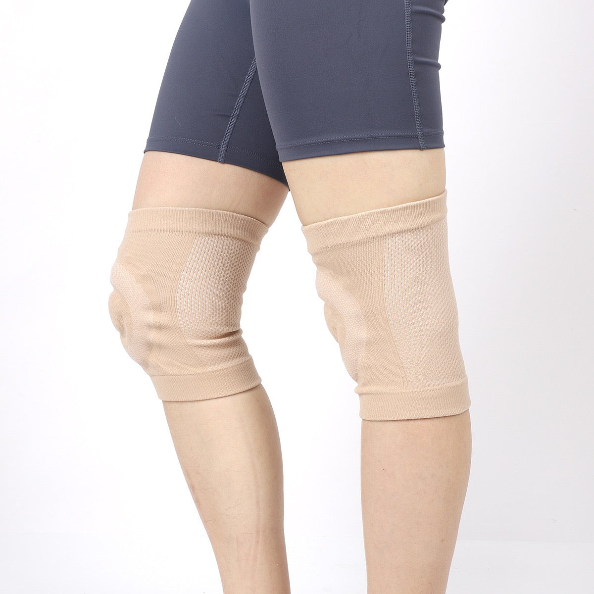 Rear view of beige silicone padded knee sleeves worn on both knees

